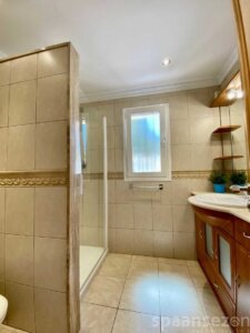 Badezimmer mit Dusche, Waschbecken und Toilette im Haus